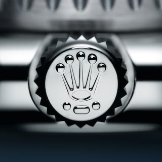 Dot-dash-dot, the three markings indicating that the winding crown of the Oyster Perpetual Deepsea Challenge is made of RLX titanium