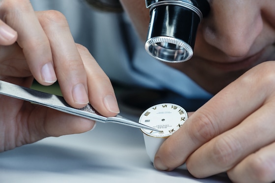 Fitting the Rolex crown applique on a dial by hand