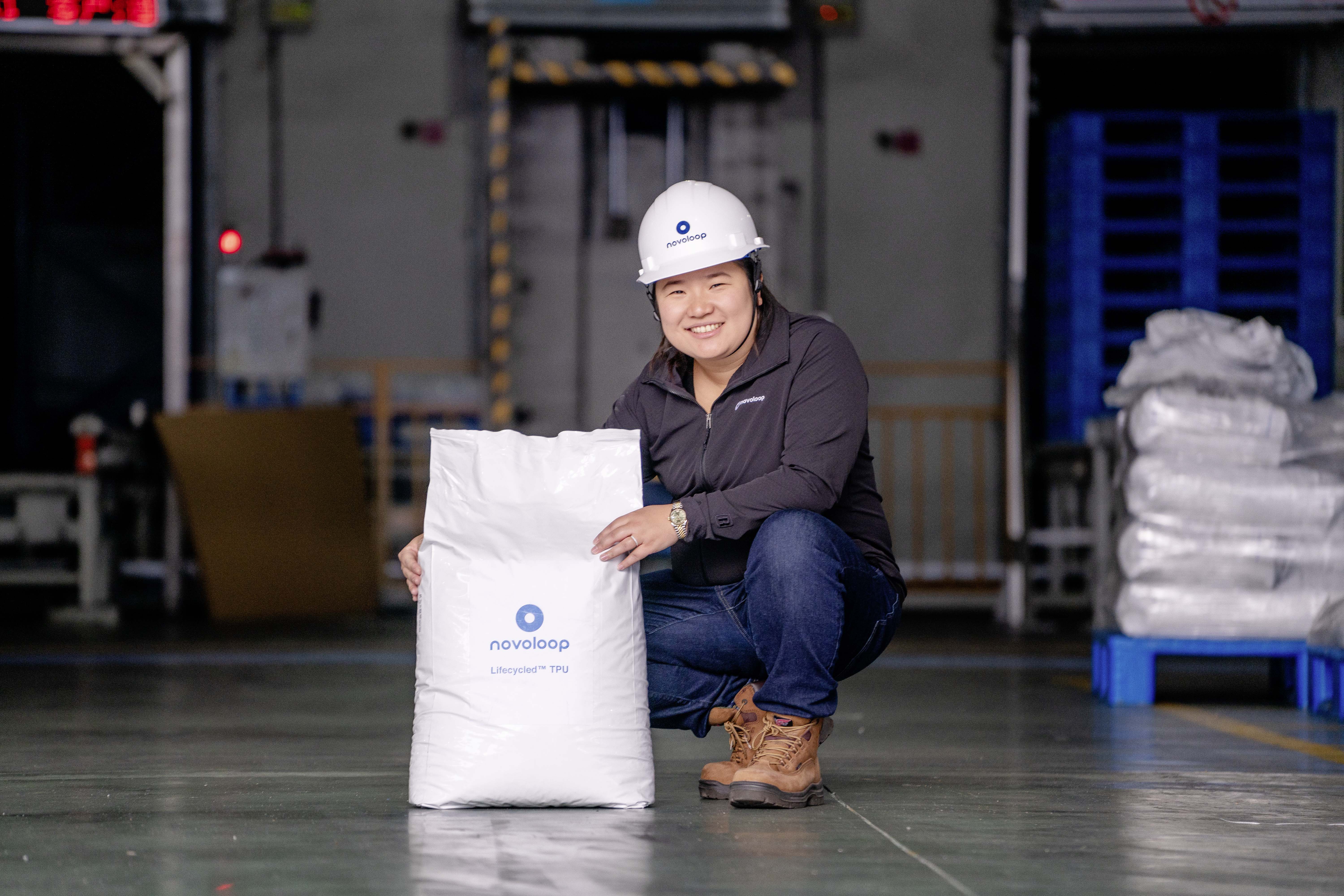 Rolex Awards Laureate Miranda Wang pictured with a bag of thermoplastic polyurethane (TPU) at the partner factory in Wenzhou, China. Wang and Novoloop co-founder Jeanny Yao are dedicated to freeing our planet of plastic pollution.
