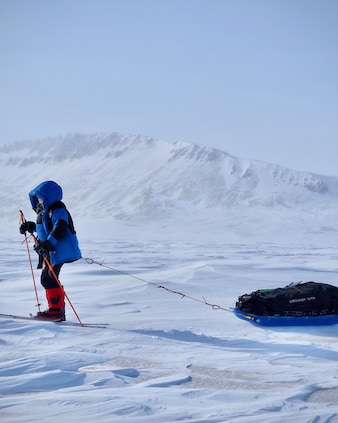 A member of the Before It’s Gone (BIG) Arctic Research Expedition team skiing through the Canadian Arctic, pulling along some of the gear that the team will need during their expedition.