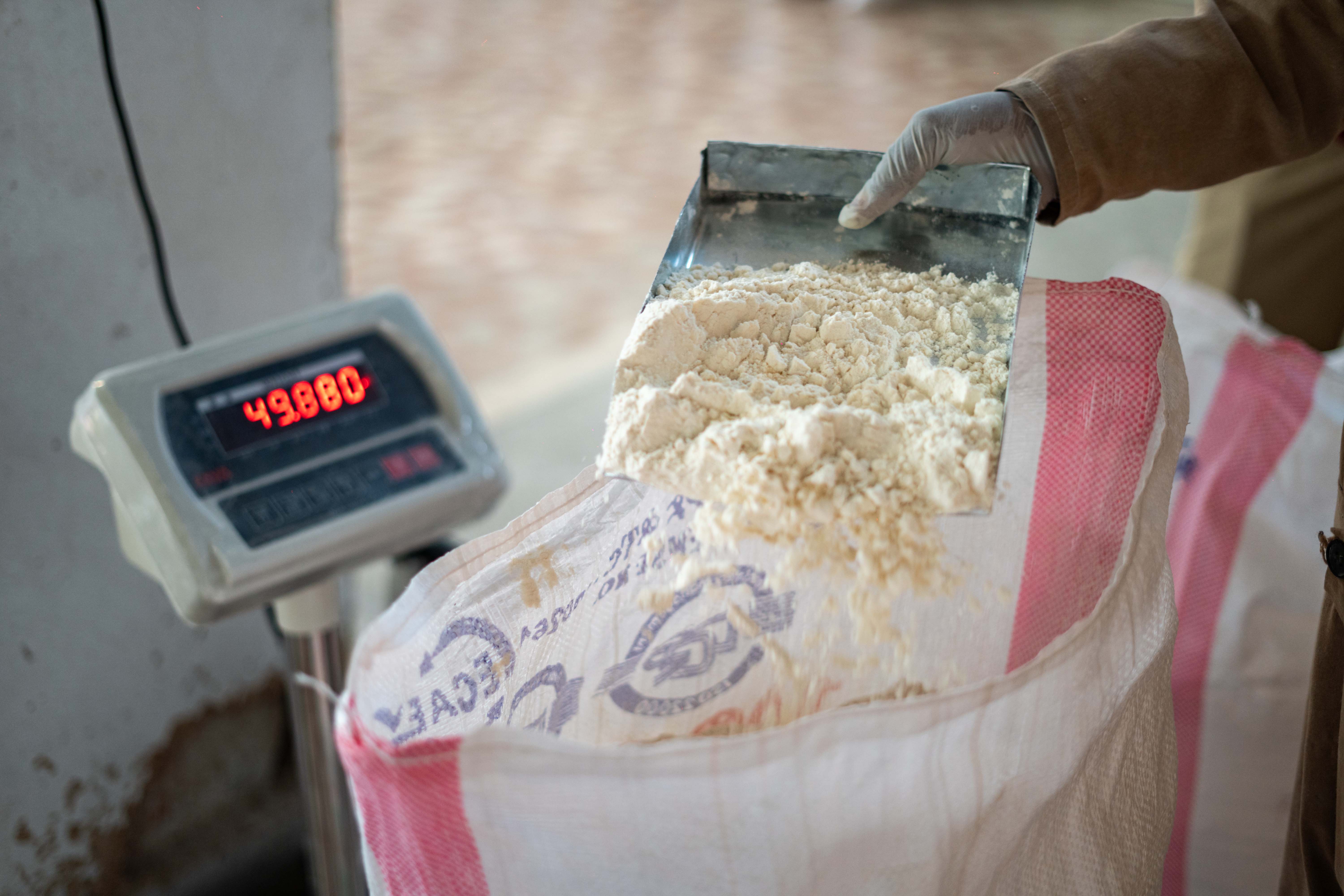 A bag is filled with wheat flour and weighed at the Wakene Flour Factory in Burayu, Ethiopia, where a Sanku dosifier is being installed. With support from the Rolex Perpetual Planet Initiative, Sanku has been able to keep improving its dosifier to make it an even more effective and appealing product.