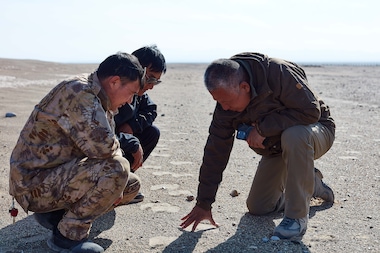 2023 Rolex Awards for Enterprise Laureate Liu Shaochuang (right) measuring camel hoof prints with team members Huerman (left) and Zhou Duojun (center). Liu is working to better understand and therefore protect the wild camels and their habitat.