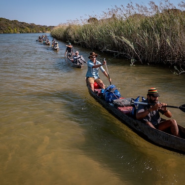 Steve Boyes and Kerllen Costa, the National Geographic Okavango Wilderness Project Angola Country Director, lead this first expedition down the Lungwevungu River in their mekoro (dugout canoes) as part of this early work of the Great Spine of Africa series of expeditions.