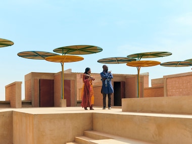 Mentor Sir David Adjaye and protégée Mariam Kamara visit the regional market designed by Kamara in Dandaji, Niger.