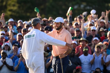 ROLEX TESTIMONEE SCOTTIE SCHEFFLER CELEBRATES WITH HIS CADDIE AFTER WINNING THE 2024 MASTERS TOURNAMENT