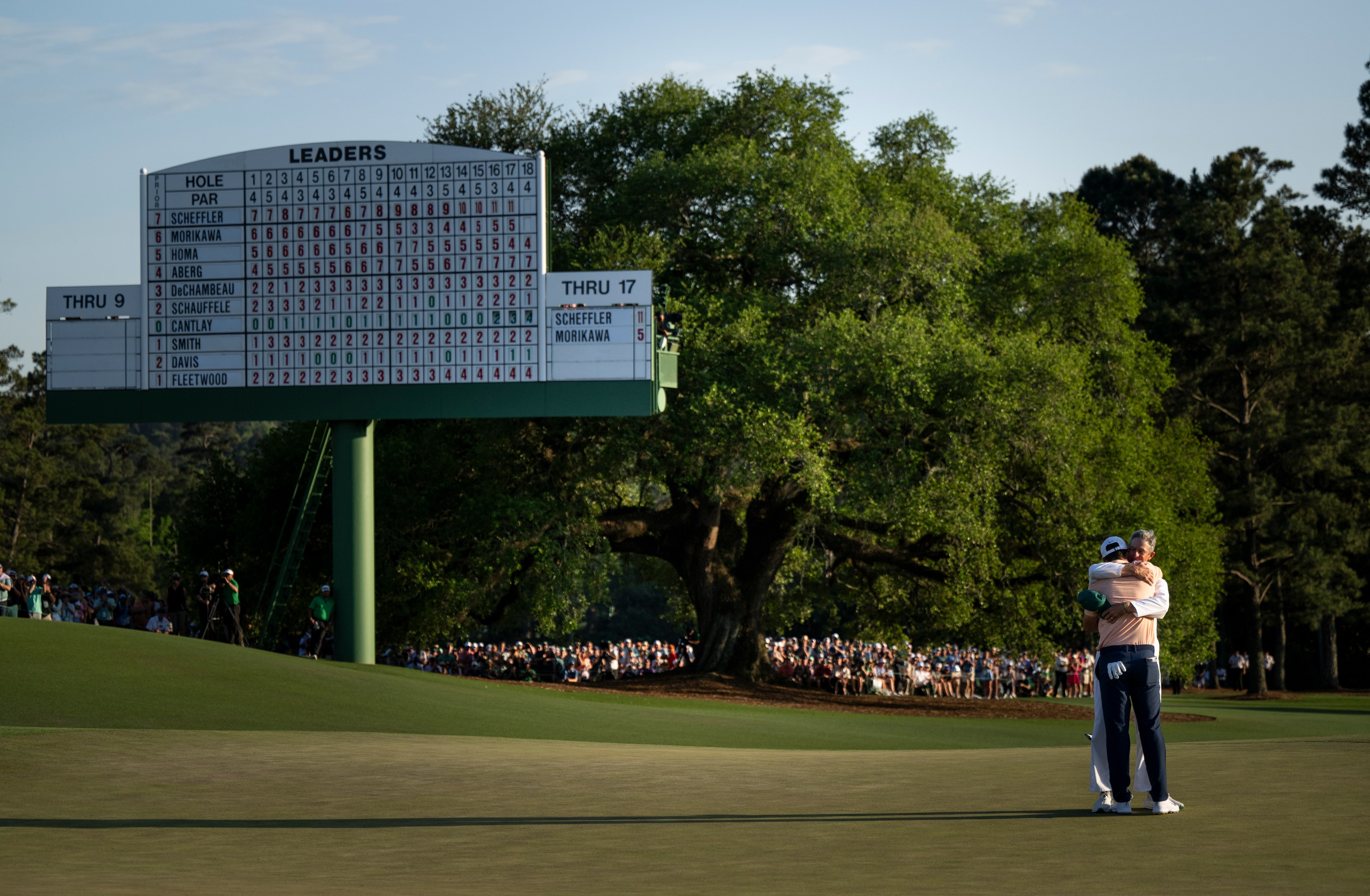 ROLEX TESTIMONEE SCOTTIE SCHEFFLER EMBRACES HIS CADDIE AFTER WINNING THE 2024 MASTERS TOURNAMENT