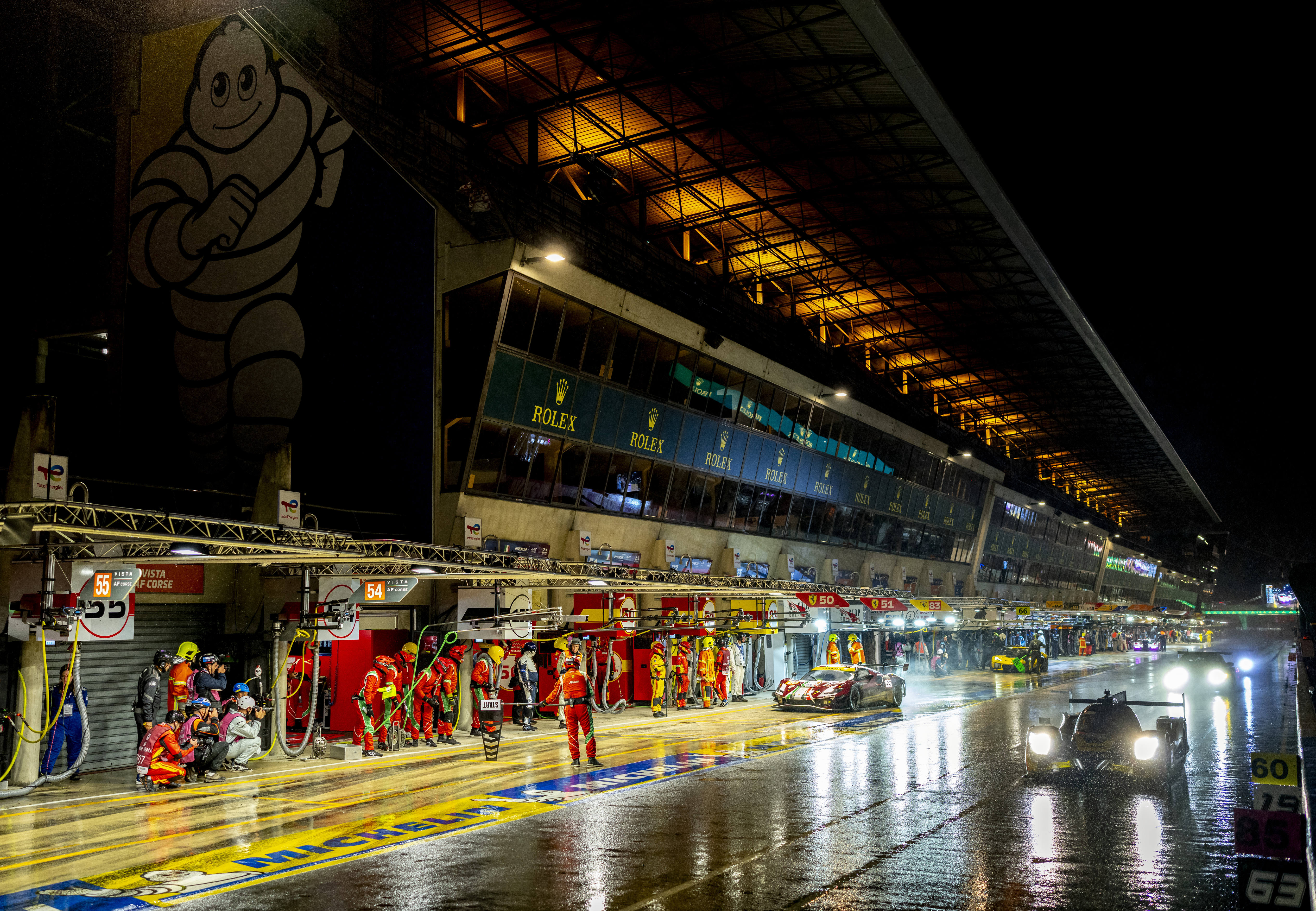 CARS EXIT THE PIT LANE DURING CHALLENGING CONDITIONS AT CIRCUIT DE LA SARTHE